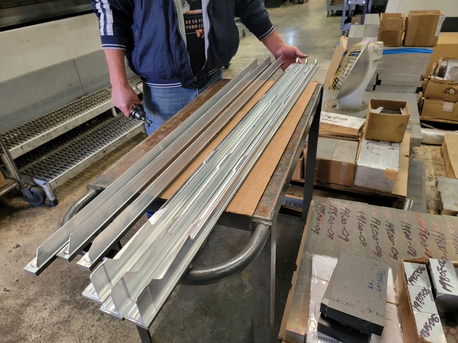 Long aluminum extrusions being prepared on the shop floor
