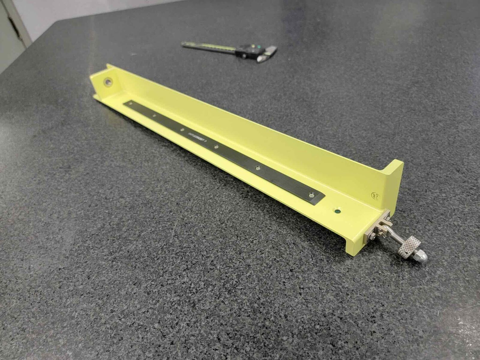 Long yellow coated bar with machined slot