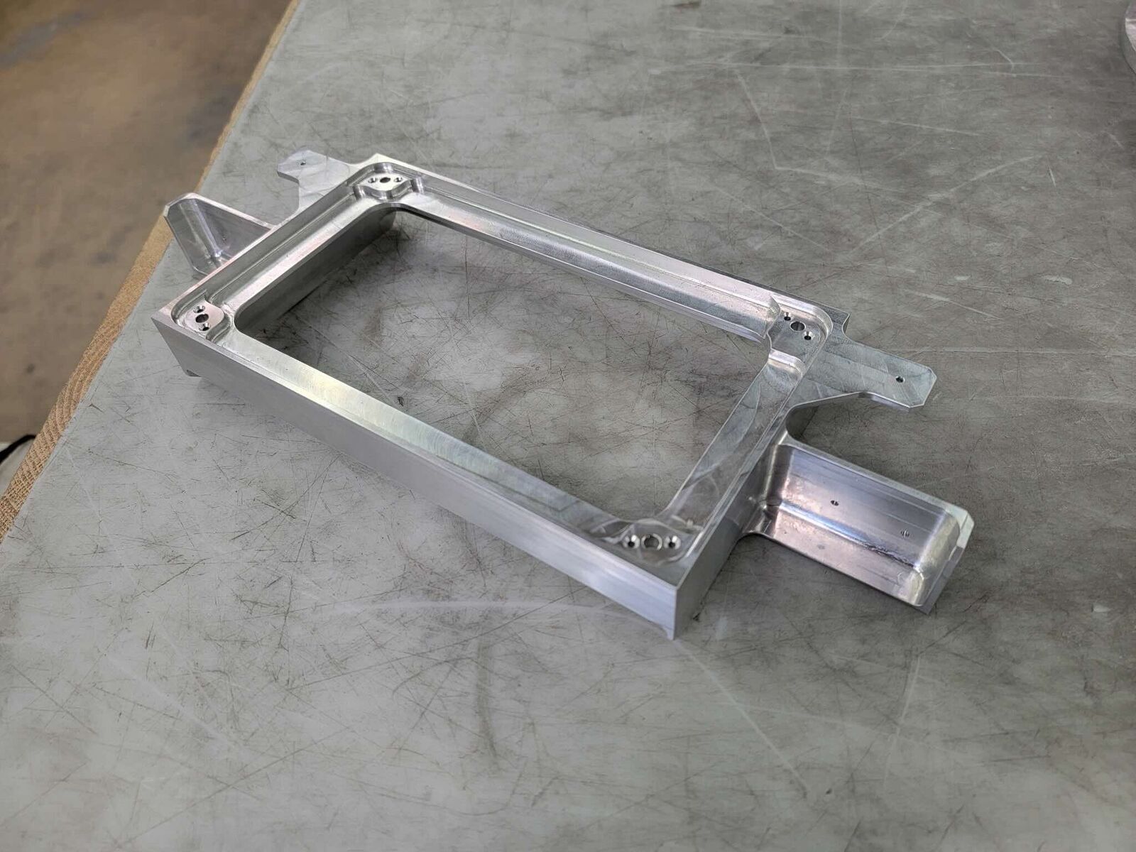 Machined aluminum rectangular frame with mounting tabs