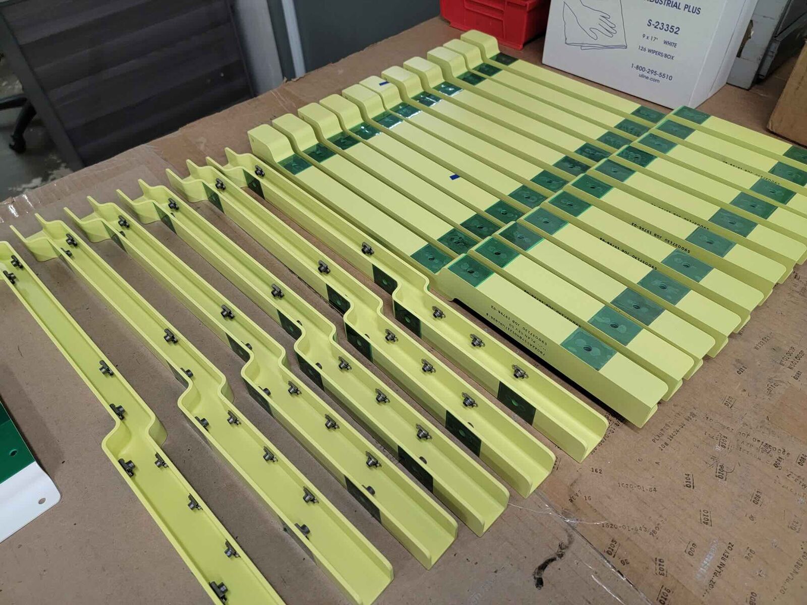 Large batch of coated yellow and green machined parts