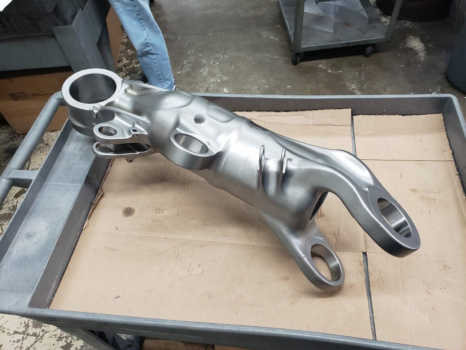 Cast aluminum arm resting in a tray