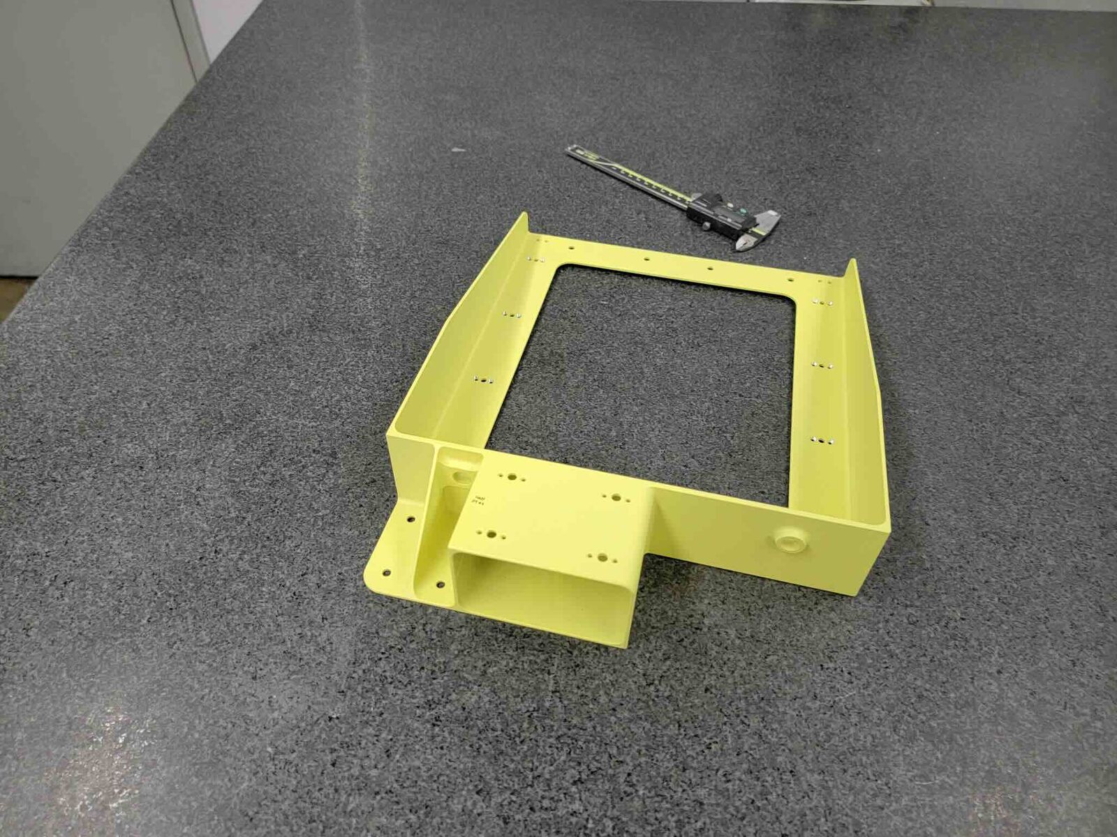 Machined frame with yellow coating and mounting holes